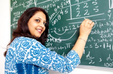 Young Indian Mathematics Teacher in a Classroom